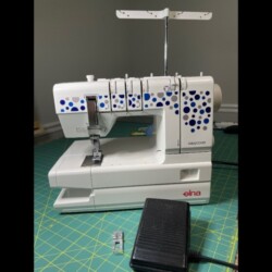 Front view of Elna EasyCover machine with foot pedal/power cord